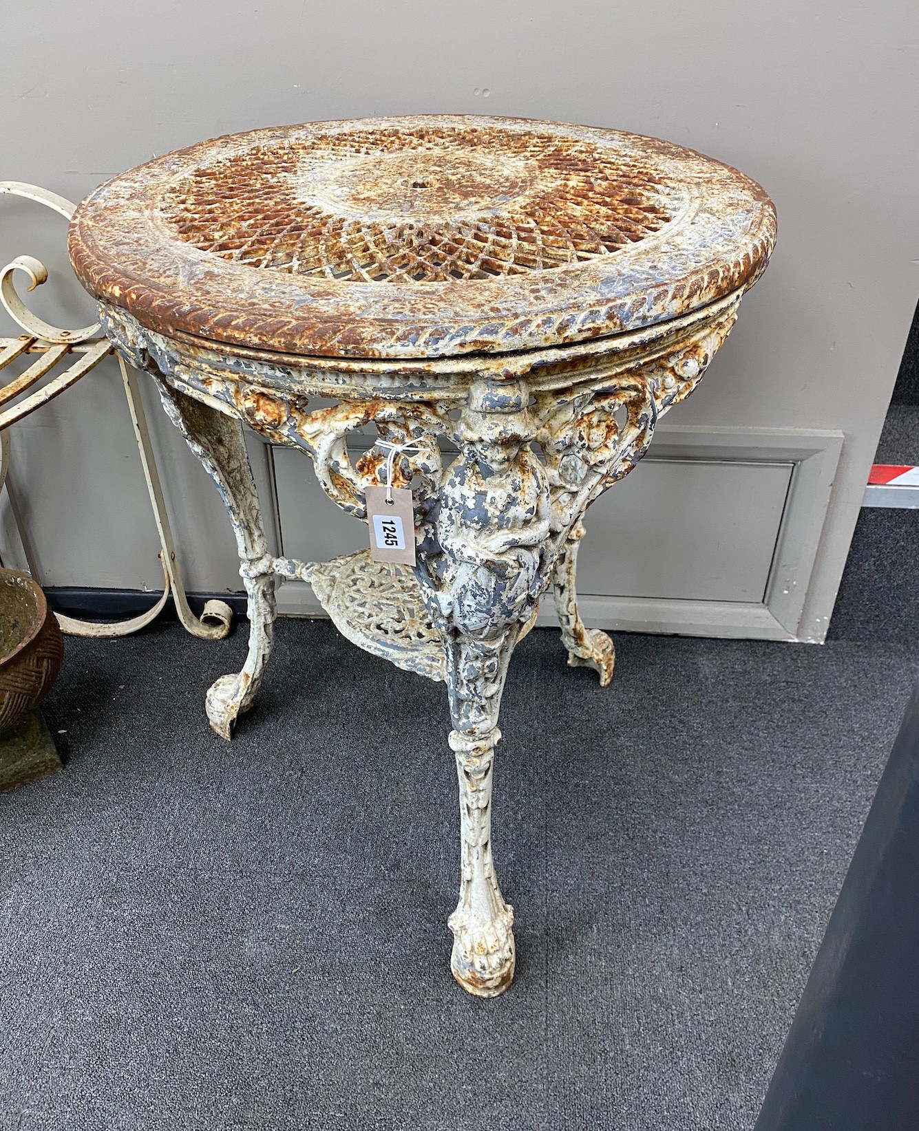 A Victorian painted cast iron circular Britannia table with pierced lattice work top, diameter 61cm, height 75cm